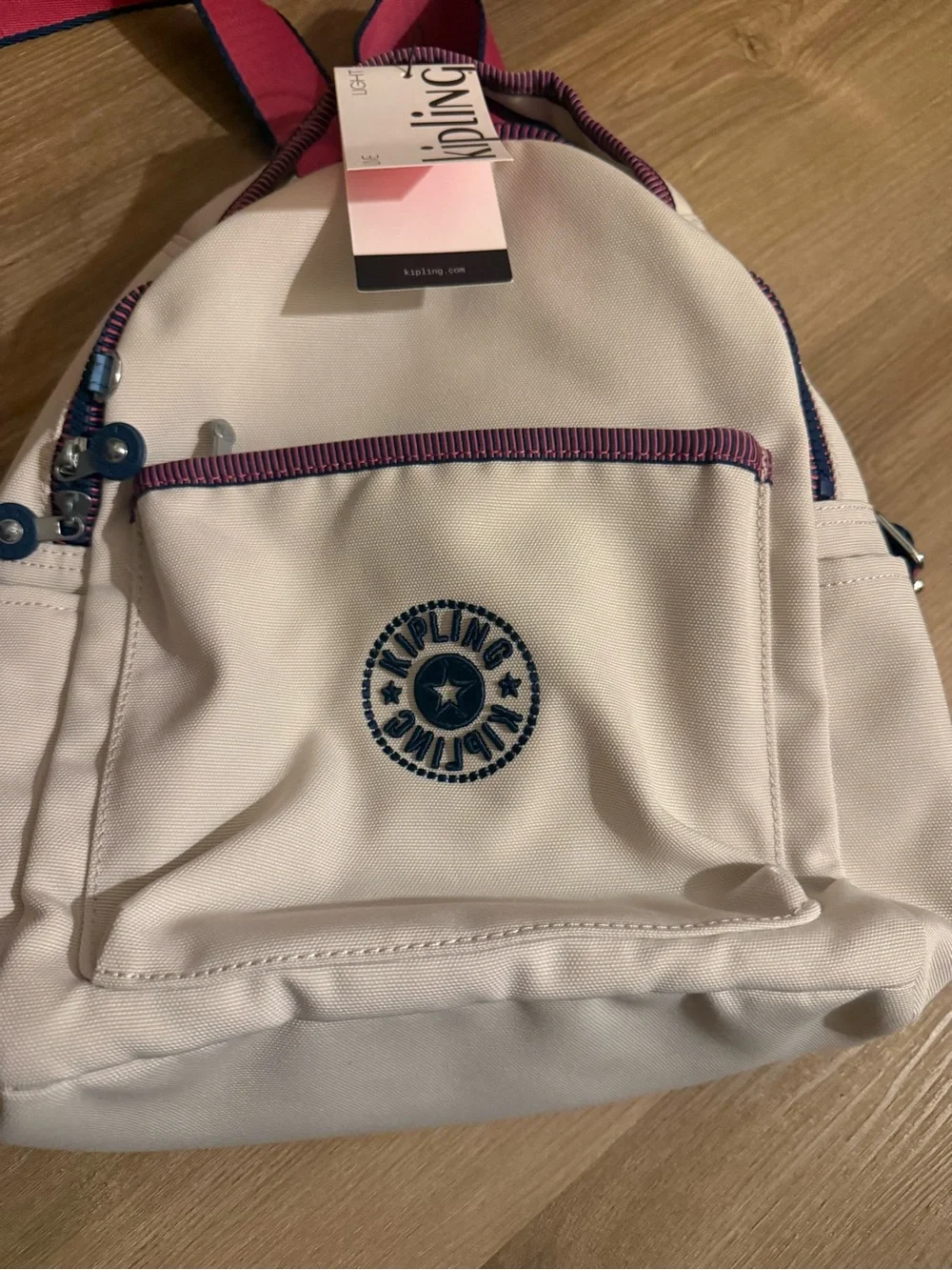 Kipling Cream Kids Backpack with Purple Trim and Blue Charm